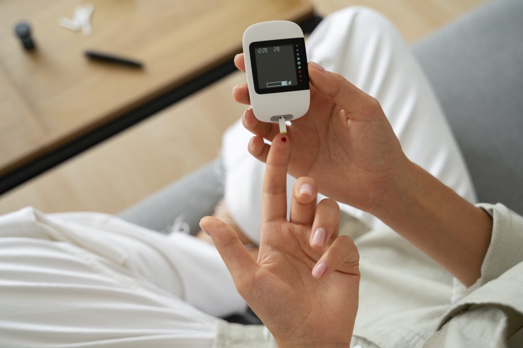 woman using a glucose meter to check diabetes