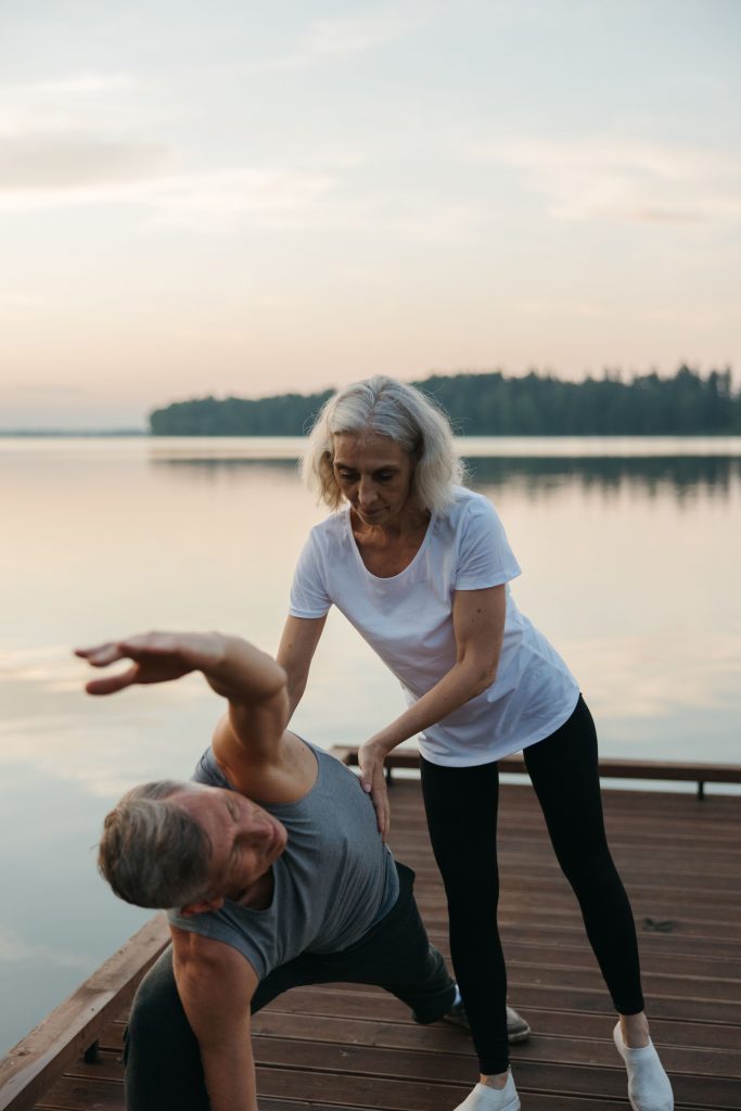 Practitioner guiding a patient through gentle movement as part of a whole-person approach to pain relief and wellness.